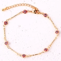 Detail of gold-plated chain bracelet featuring red enamel evil eye charms and lobster clasp - Red Bracelet