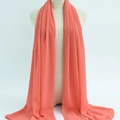 Chiffon hijab scarf in elegant coral pink draped over a mannequin torso - 46