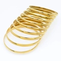 Minimalist gold plated titanium steel bangles in a high-polished stacked ring set - Inner Diameter 55mm / Gold (9 Rings)