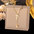 Detail of gold titanium steel necklace with letter T pendant and small square charm - Letter T-Gold
