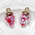 Detail of teardrop glass pendants filled with red and blue star sequins and gold caps - Water Drop / Red