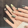 Detailed view of black and cat-eye press-on nails with 3D bows and star accents - Large (L) / Gold Green Cat Eye Black Bow Star Style (54-Short Trapezoid)