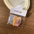 Set of macaron-colored matte hair clips in pink, yellow, and blue on wood background - Ellipse / 10 Pieces Pack / Macaron Color