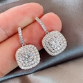 Luxurious square halo stud earrings with micro-pave crystals on a silk background - White Gold