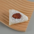Realistic PVC meat rice dumpling food model with white rice grains on a wooden tray - Beef Rice Dumpling