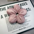 Pink satin scrunchie with a 3D flower petal design and a smooth glossy finish - Pink