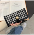Detail of houndstooth wallet with black leather trim and matte gold metal buckle - Long Black
