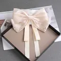 Large pink silk ribbon bow hair clip with crystal butterfly accents and long streamers - Beige