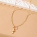 Minimalist gold chain necklace featuring a polished small cross pendant on a beige surface - HS1459-3 Gold Single Layer Simple Cross Necklace