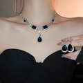 Macro detail of silver necklace and earrings with black teardrop stones on a model - 17# Silver Water Drop Rectangle (2-Piece Set)