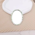 Oval mini makeup mirror accessory with green and white rhinestones on beige knit background - Colorful Green Oval