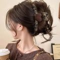 Brown tweed hair claw clip with flocked heart detail shown on a model's hair - Coffee Heart Leopard Style