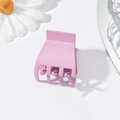 Close-up of a small purple plastic shark hair claw clip for high ponytail styling - Plastic / Purple