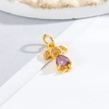 Detailed view of a golden girl pendant with purple heart stone and white zircon inlay - Little Girl - Purple Heart