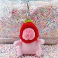 Pink Capybara plush keychain with strawberry hat decoration on macaron foam background - Strawberry Hat Pink + Silver Clip