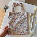 Detailed close-up of a floral cotton handbag with vintage metal button and reinforced stitching - Beige Base Floral(T-38)