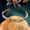 Detailed macro view of handmade colorful raw crystal stones wired onto a gold crown headband - Fluorite with Gold Wire Gold Headband