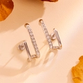 Macro detail of silver U-shaped stainless steel earrings with sparkling zircon inlay - Silver Irregular Stud Earrings with Zircon (H203)