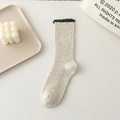 Beige ribbed crew socks with black lace trim edges in a minimalist lifestyle setting - One Size / Grey-Beige