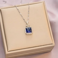 Elegant gold titanium necklace with a blue sapphire pendant and small crown detail - 6030 Square Blue Zircon / Silver