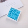 Sky blue shredded raffia paper filler for gift boxes inside a white square package - 20g per Pack / Lake Blue