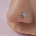 L-shaped silver nose stud with turquoise star design on silicone model display - Blue Cross Star