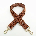 Close-up of ethnic geometric weave bag strap with golden metal lobster clasps and buckles - Dark Brown