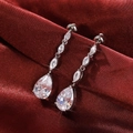 Silver drop earrings with marquise and pear-cut cubic zirconia on red silk fabric - White Gold