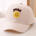 Close-up of the detailed smile sun embroidery on a beige kids cotton baseball cap - 52cm 2-5 Years Old / Off White