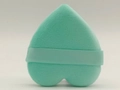 Detail of a heart-shaped teal velvet powder puff with matching finger ribbon strap - Green