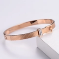 Dettaglio del bracciale a fibbia in oro rosa con strass scintillanti e finitura lucida - Oro rosa