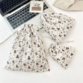 Three sizes of embossed seersucker drawstring bags with cartoon puppy pattern detail - Skating Dog