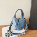 Two-tone denim bucket bag with contrasting light and dark blue patchwork and orange stitching - Blue