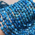 Macro shot of irregular natural blue apatite nugget beads with polished oily luster - Apatite