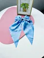 Sky blue satin hair clip with double-layered bow and long streamers on a pink mat - Lake Blue