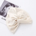 Champagne silk satin adjustable sleep cap with elegant knotted design for hair care - Crossed Apricot