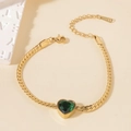 Detail of gold curb chain bracelet with heart-shaped green stone and S.STEEL stamp - Heart Green Gemstone Bracelet