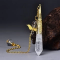 Macro detail of hexagonal white crystal pendant with golden filigree cap and wing decor - Gold White Crystal