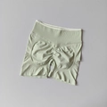 Detailed view of seamless mint green yoga shorts with high waist and scrunch butt design - Fruit Green