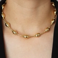 Close-up of 18k gold plated oval beads necklace worn on neck with polished metal finish - DN240552-C Gold Oval Bead Style