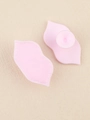Detailed view of pink lip-shaped silicone exfoliator with soft bristles and suction handle - Light Pink