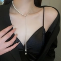 Elegant pearl and silver chain Y-necklace with tassel detail on fashion model - Style 11 (HN3365)