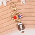 Golden American football keychain with glitter brown ball and red love heart pendant - Gold American Football US Flag Style
