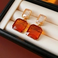 Macro view showing stacked champagne and orange square crystals in a premium gift box - Orange (Silver Needle)