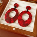 Macro shot of red marble textured acrylic oval earrings in a wooden jewelry box - Silver Earring Post - Red