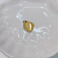 Detailed shot of golden heart-shaped pendant with amber cat-eye stone and pavé setting - White Heart Cat Eye