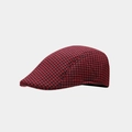 Detailed close-up of red and black houndstooth pattern wool texture on a beret cap - Dark Red
