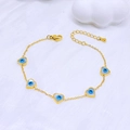 Bracciale a catena dorata con pendenti a cuore occhio blu su tessuto bianco - Cuore