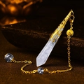 Natural light blue crystal hexagonal pendant with gold filigree cap on dark rock - Gold White Crystal