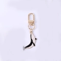 Golden keychain with black and white whale pendant and metal alloy clasp - Black Whale